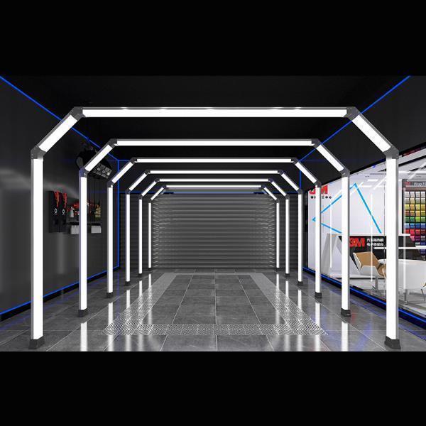 How does LED lighting improve visibility in an automotive workshop?