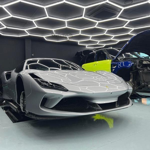 Why do adjustable LED lights make it easier to detect overspray on non-painted surfaces?