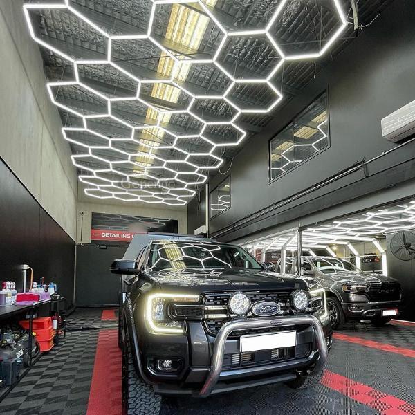 Why is adjustable brightness important in car repair shop lighting?