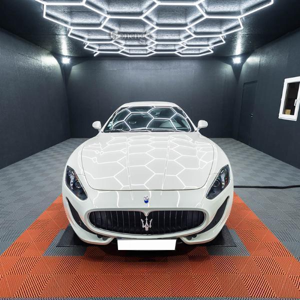 Why do car repair shops prefer dimmable LED lights over traditional lighting?