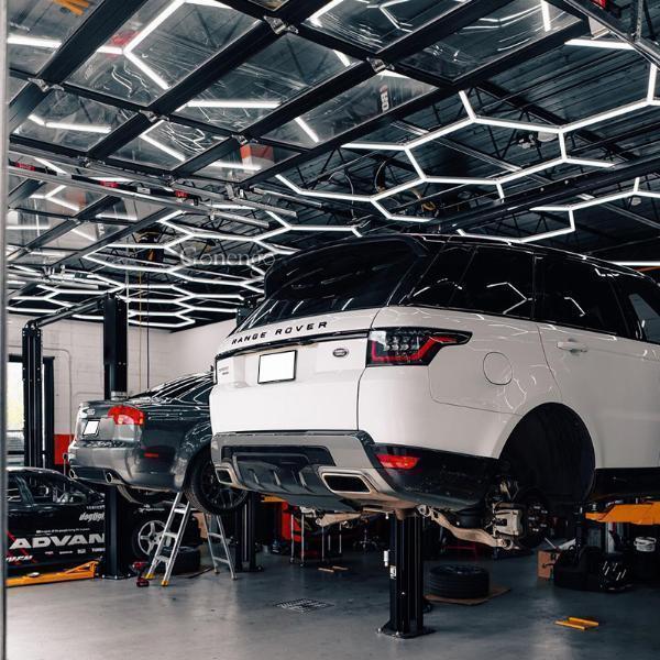 Why is the ability to adjust lighting levels critical in car repair shops?