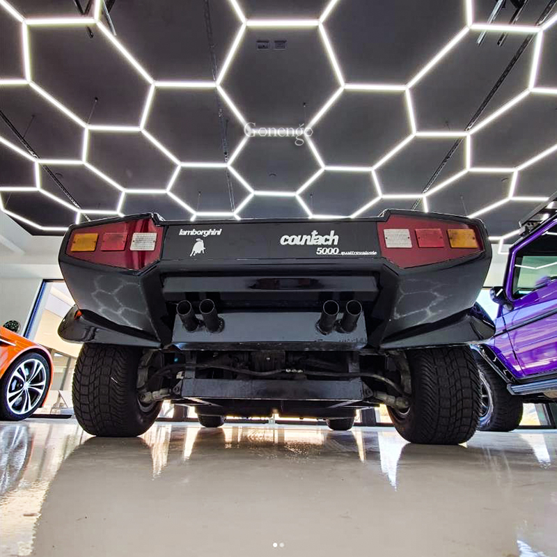 What are the financial benefits of switching to LED lights in car workshops?