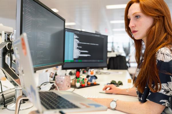 A woman in an office researching sales enablement during a meeting